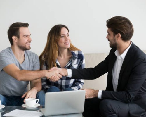 Happy family couple renters tenants handshaking realtor landlord at meeting making real estate deal for apartment rent purchase, clients customers and adviser insurer shake hands, mortgage concept