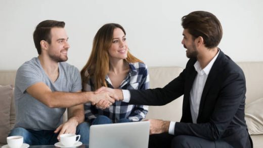 Happy family couple renters tenants handshaking realtor landlord at meeting making real estate deal for apartment rent purchase, clients customers and adviser insurer shake hands, mortgage concept